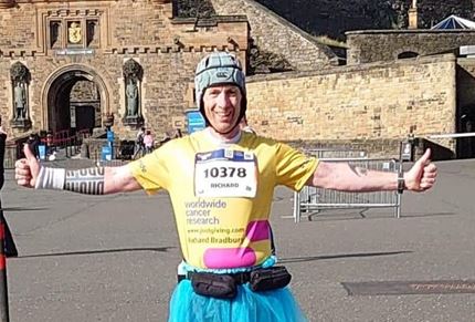 Richard standing in front of Edinburgh castle as part of Edinburgh Marathon Virtual Challenge