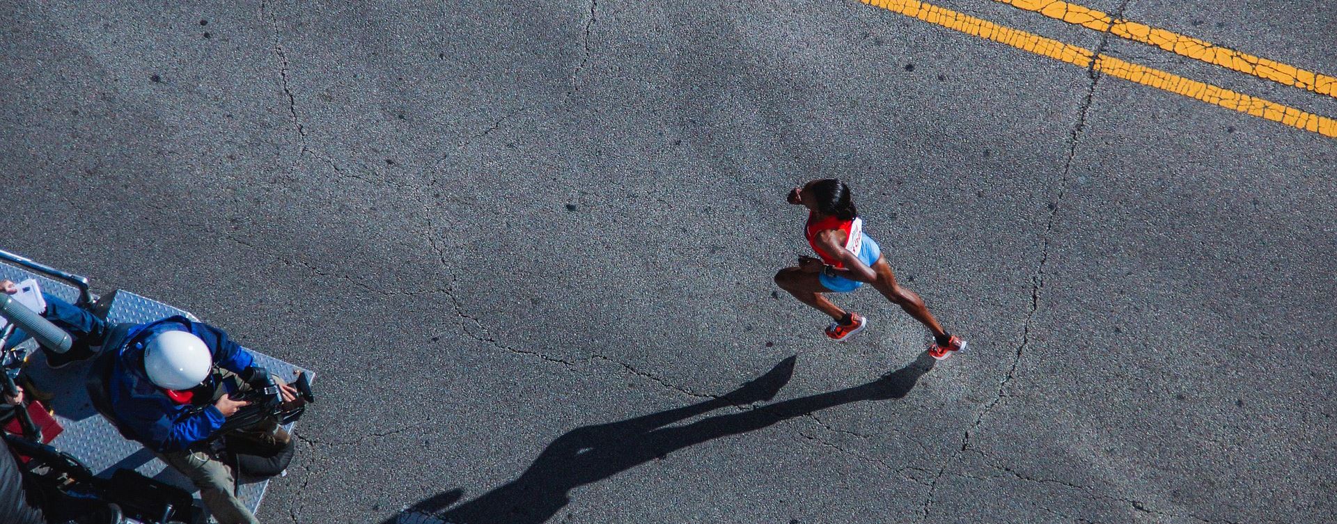 An aerial photo of a runner on a road
