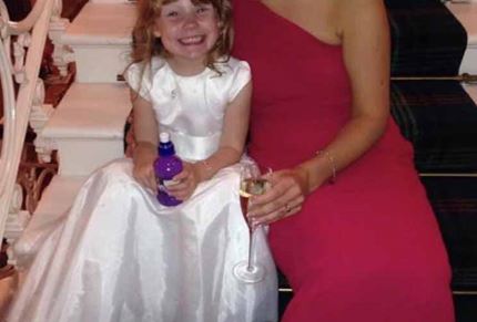 Suzanne and her daughter smiling for a photo at a wedding