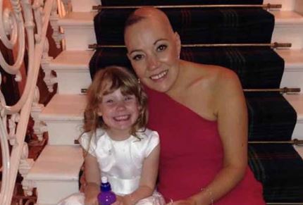 Suzanne and her daughter smiling for a photo at a wedding