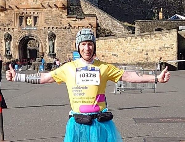 Richard standing in front of Edinburgh castle as part of Edinburgh Marathon Virtual Challenge