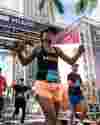 Runners in the Miami Half Marathon cross the finish line happily.