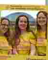 Three women wearing Worldwide Cancer Research t-shirts stand in a Worldwide Cancer Research selfie frame.