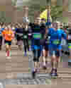 Runners cheering and smiling in the Bath Half Marathon
