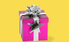 A pink gift wrapped in a silver ribbon on a yellow background