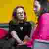  People having a serious conversation against a yellow background