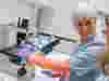 Judy Murray Using Microscope And Smiling