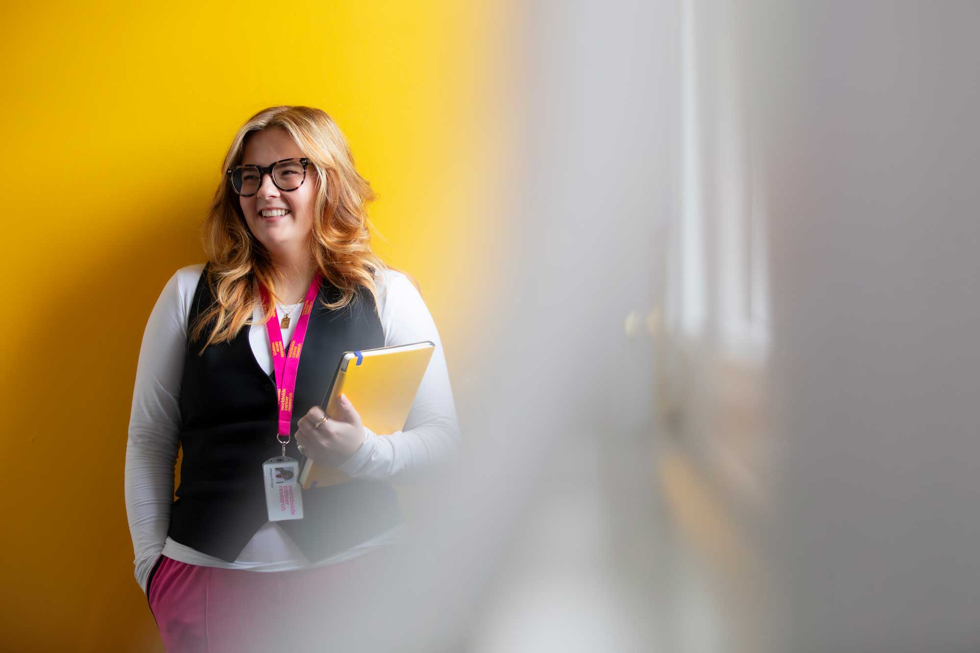 Worldwide Cancer Research team member standing against a wall