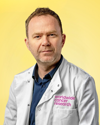 An image of Dr Niall Kenneth wearing a lab coat against a yellow background