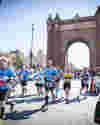 Picture of Barcelona Half Marathon runners passing the Arc de Triomph