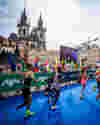 Picture of Prague Marathon runners approaching the finish line in Old Town Square.